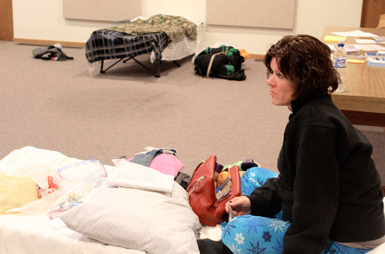 Farrah Lynn gets settled during her first night staying at Oak Harbor’s emergency shelter for homeless. She’s still recovering from being sick all winter living in a tent. “I feel blessed to be here,” she said. Photo by Patricia Guthrie/Whidbey News-Times
