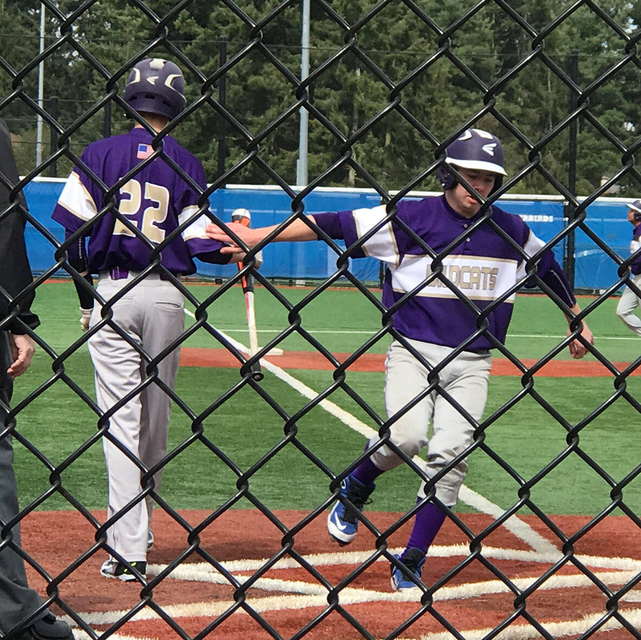 James Besaw is greeted by Joseph Dixon (22) at home plate after scoring on a bases loaded walk to Cory Roberts. (Photo by Teresa Besaw)