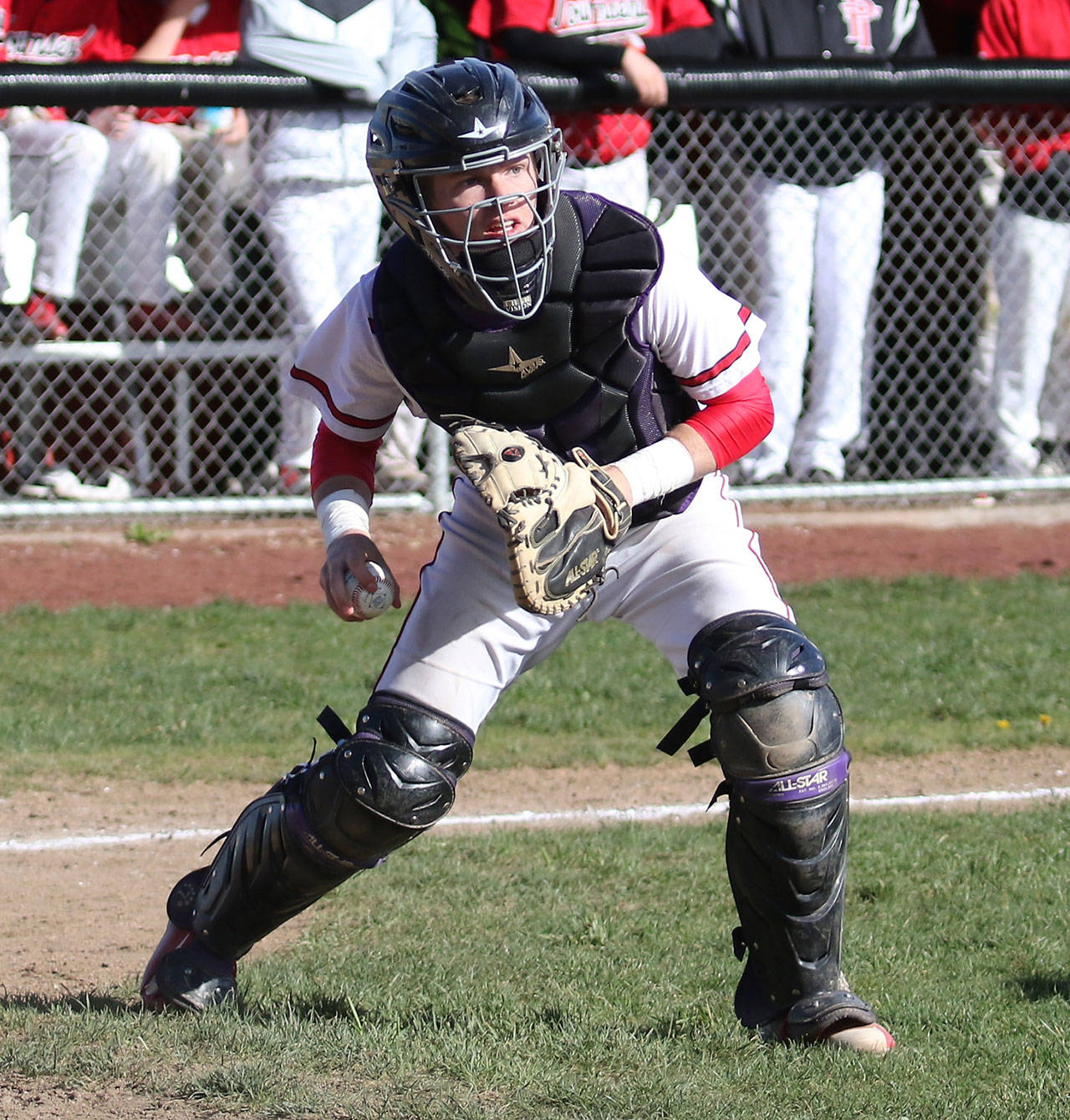 Coupeville catcher Taylor Consford prepares to fire to first to force out a runner. (Photo by John Fisken)