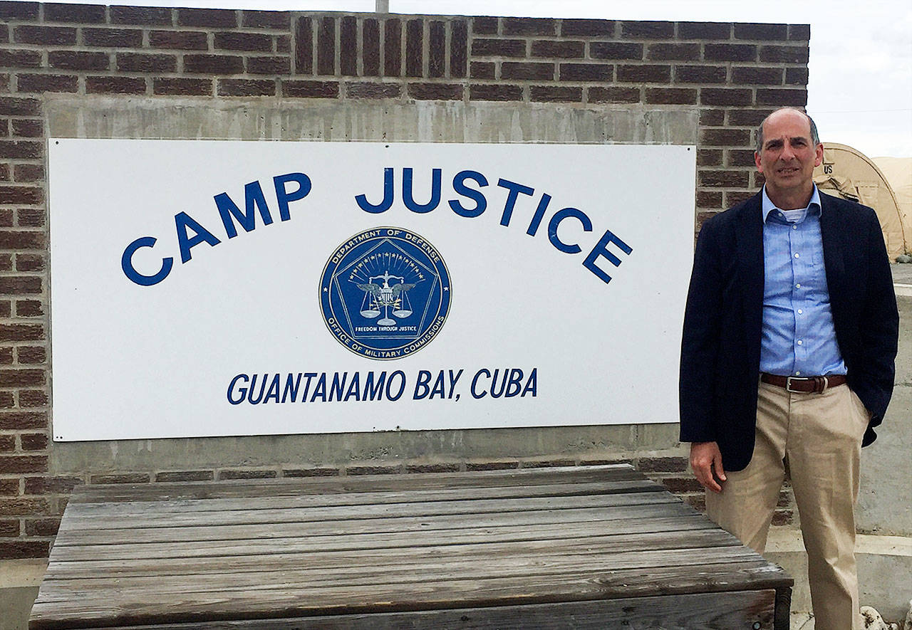 Submitted photo                                Island County Prosecutor Greg Banks stands next to the Camp Justice sign during his recent trip to Guantanamo Bay.