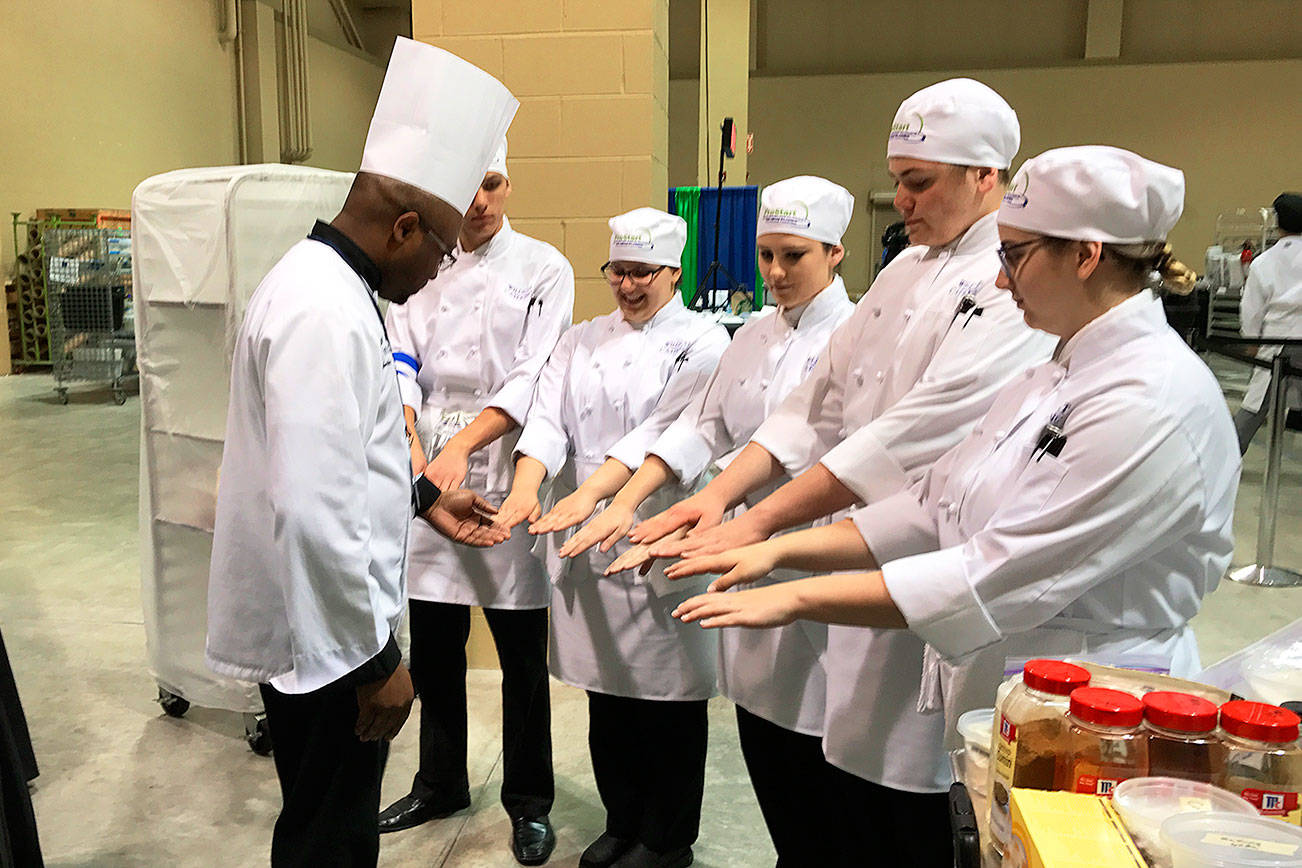 A judge checks the Oak Harbor culinary arts team for clean and sanitary hands at the ProStart National Invitational, which was held April 28-30 in Charleston, S.C. Oak Harbor placed 16th out of 48 teams. Photo courtesy Mary Arthur