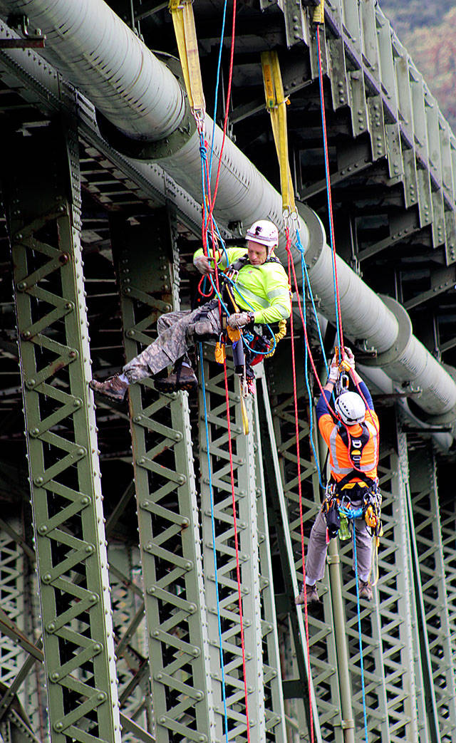 Photos be Jessie Stensland / Whidbey News-Times                                Sean Tanner, left, and another bridge climber working for the state Department of Transportation inspect Deception Pass Bridge Wednesday.