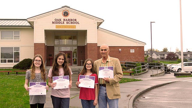 Photo by Stuart Bassett                                From left, students Natalie Ballard, Anissa Randolph, Danelle Hays and their science teacher, Alan Bailey, show off certificates of the team’s first-place win in the eCYBERMISSION competition.