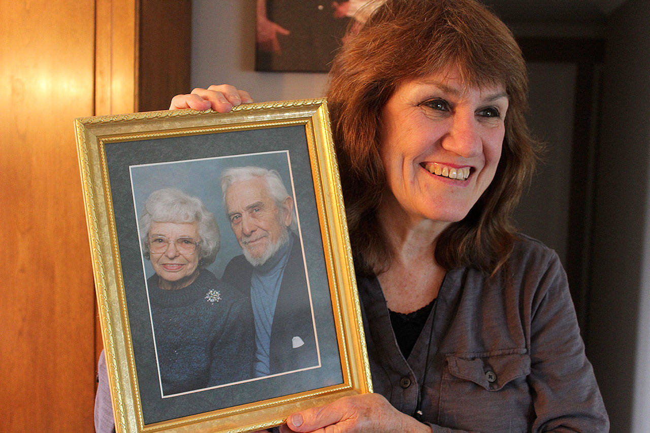 Carmel Walter of Oak Harbor holds a photo of her adoptive parents, Betty and Dave Baird, who moved to Oak Harbor when they retired. The couple adopted Walter from Ireland in 1952. She’s one of thousands of people searching for Irish mothers who were forced to give up their children by the Catholic Church because they were not married.                                Photos by Patricia Guthrie/Whidbey News-Times