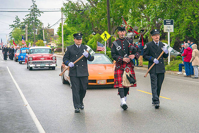 Central Whidbey Fire and Rescue Captain Jerry Helm plays bagpipes down the parade route. 2016 File Photo by Pam Headridge.