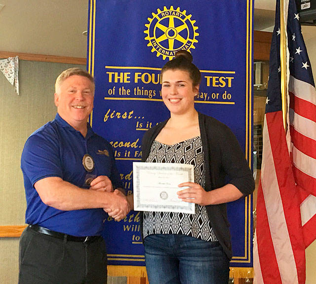 Rotary President Greg Smith presents Meredith Bain with her Student of the Month certificate. Photo provided.