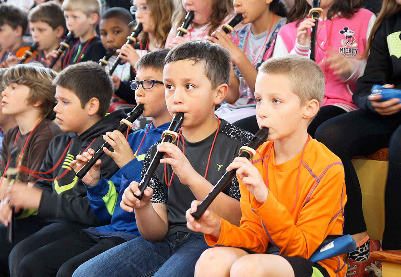 From left, Jaeden Altheiser, Carlos Orozco, Mason Burns, William Greiger and Jacob Ward play recorders to accompany the Saratoga Orchestra Wednesday at Oak Harbor Elementary. Third and fourth grade students from Broad View Elementary, Oak Harbor Elementary and Hillcrest Elementary took part in the &ldquo;Link Up: The Orchestra Rocks&rdquo; concert. Photo by Daniel Warn/Whidbey News-Times