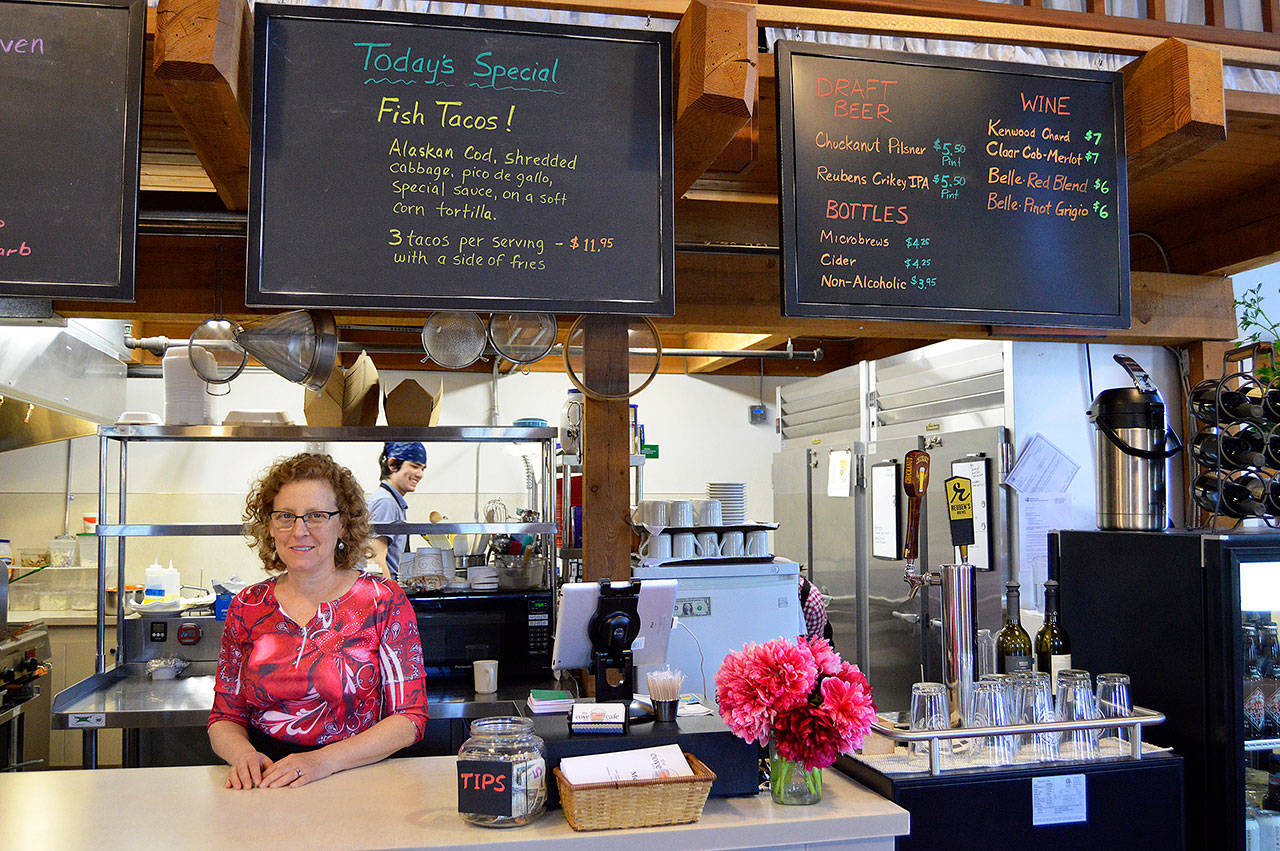 Michele Lynn works behind the counter of her new restaurant The Cove Cafe, located inside the Coupeville Wharf. Photo by Megan Hansen/Whidbey News-Times