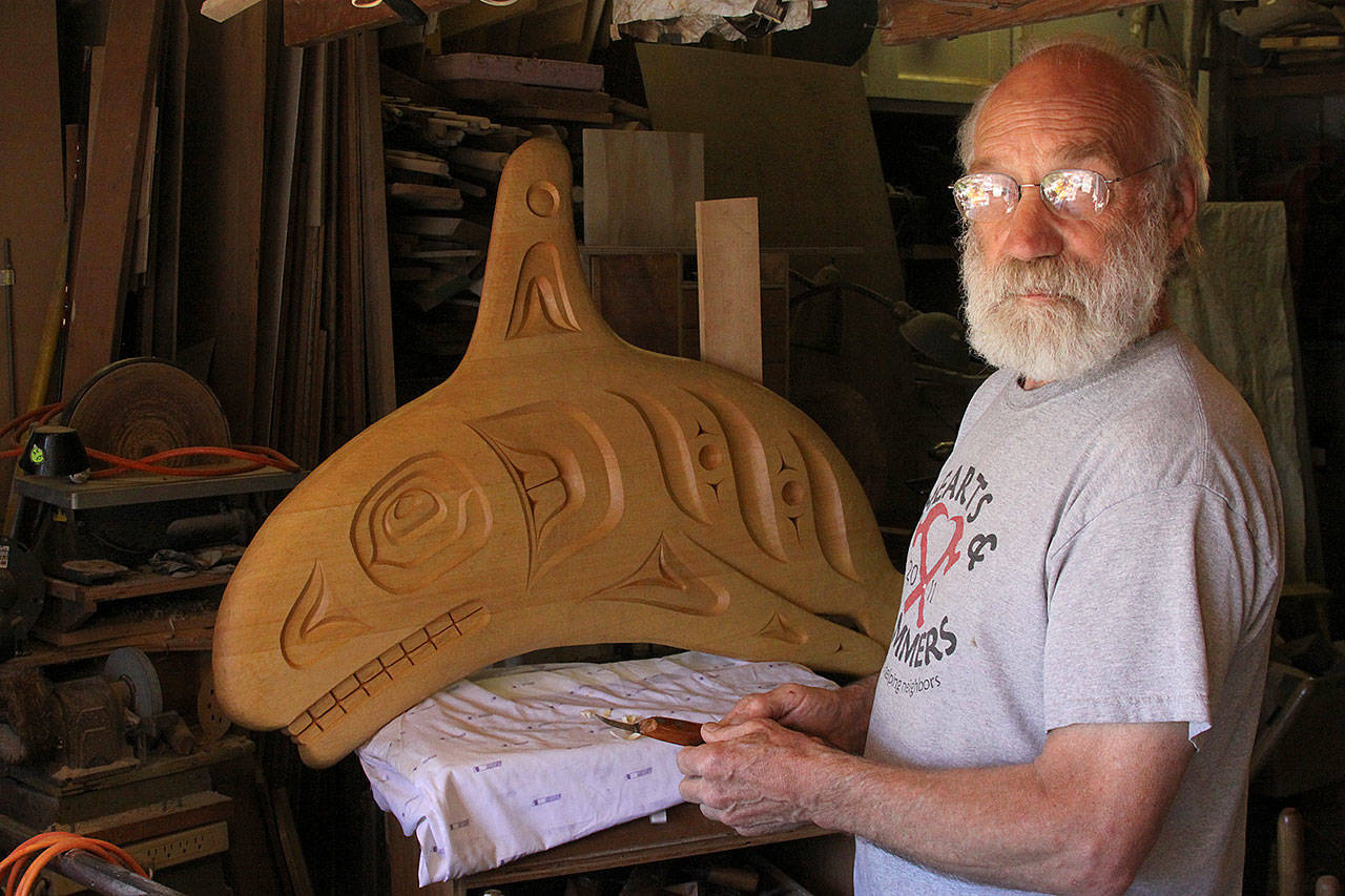 Jim Short stands before a wood carving Friday, May 26, 2017, in his Coupeville shop. The carving will be part of a whale bell that is coming to the Coupeville Wharf. An unveiling celebration will take place at 3:30 p.m. Saturday, June 3. Photo by Ron Newberry/Whidbey News-Times