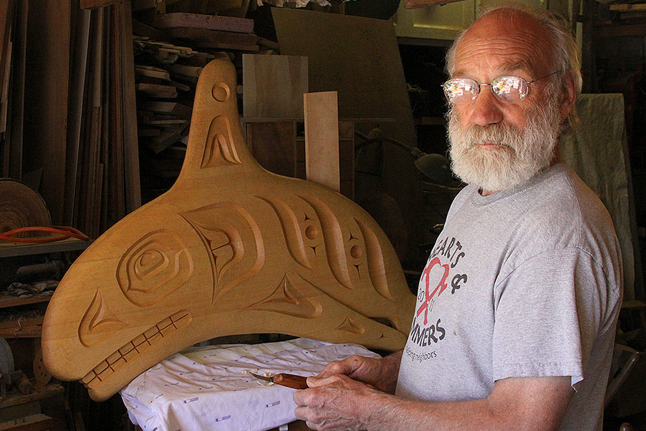 Jim Short stands before a wood carving Friday, May 26, 2017, in his Coupeville shop. The carving will be part of a whale bell that is coming to the Coupeville Wharf. An unveiling celebration will take place at 3:30 p.m. Saturday, June 3. Photo by Ron Newberry/Whidbey News-Times