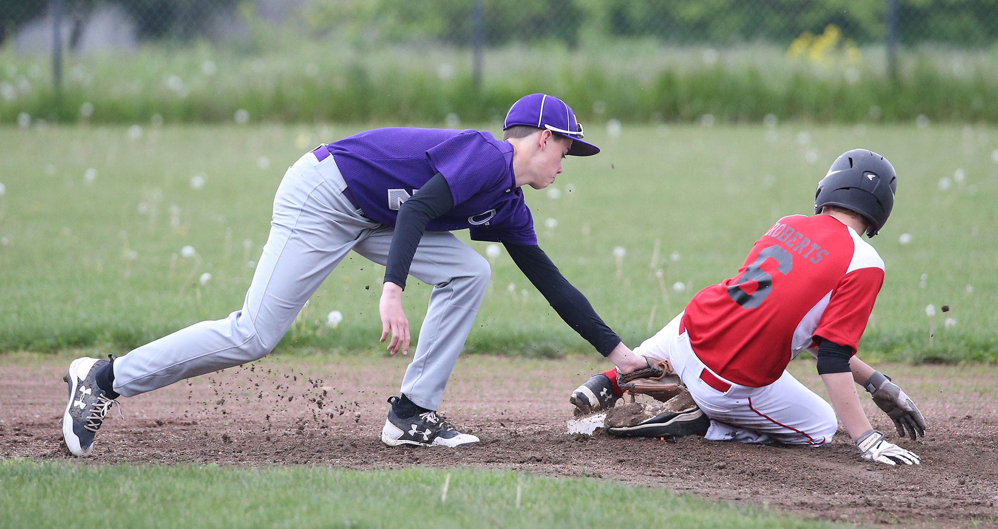 Coupeville’s Cody Roberts steals second base ahead of a tag by Gage McLeod. (Photo by John Fisken)