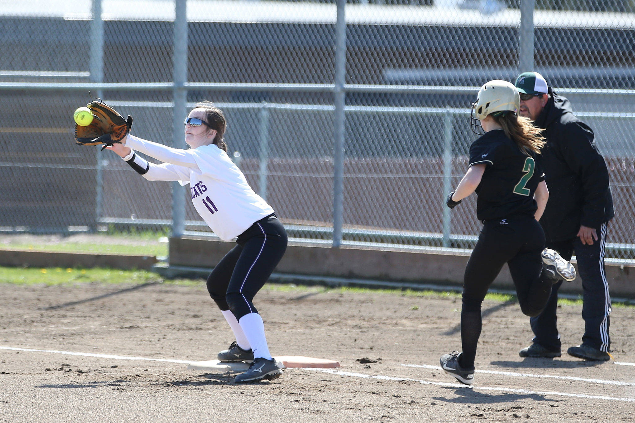 Taylor Wilson takes a throw that forces out Getchell’s Avery Holscher. (Photo by John Fisken)