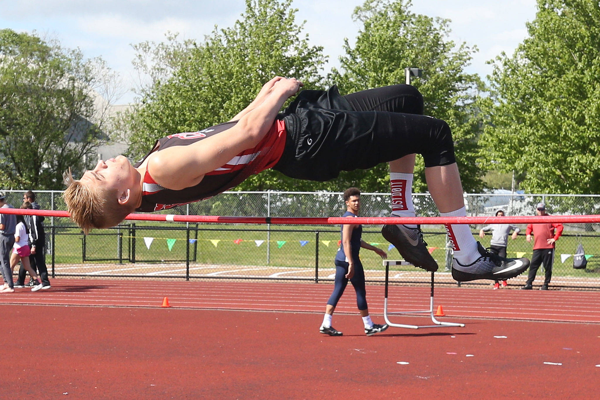 Ariah Belpler leaps his way to first place in the district high jump. (Photo by John Fisken)