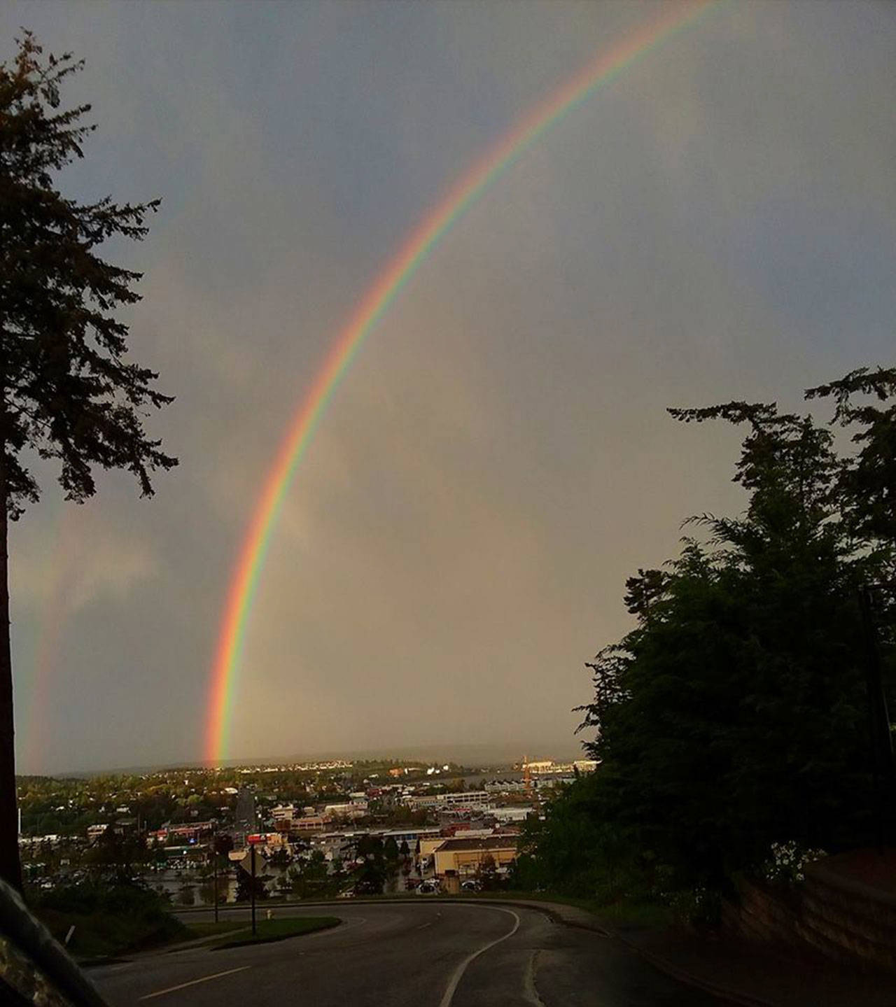 A rainbow arcs over Oak Harbor earlier this spring. At left, a second band shows up faintly. Photo by Wilma Vernon LeDuc‎