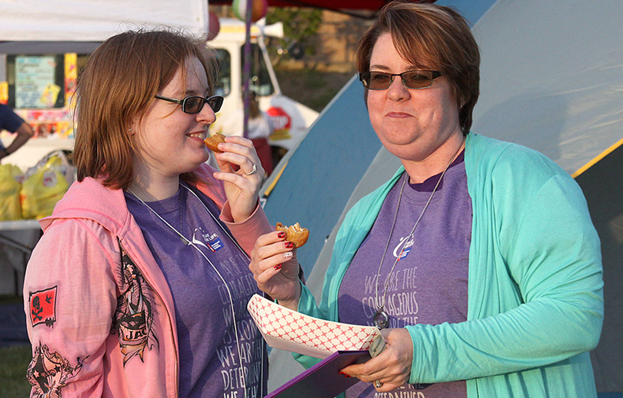 Dawnelle Conlisk shares a snack and some laughs with her daughter Mary at the The Relay for Life of Whidbey Island event Friday, June 2, 2017, at North Whidbey Middle School in Oak Harbor. Conlisk has been dealing with cancer for 22 years. Photo by Ron Newberry/Whidbey News-Times