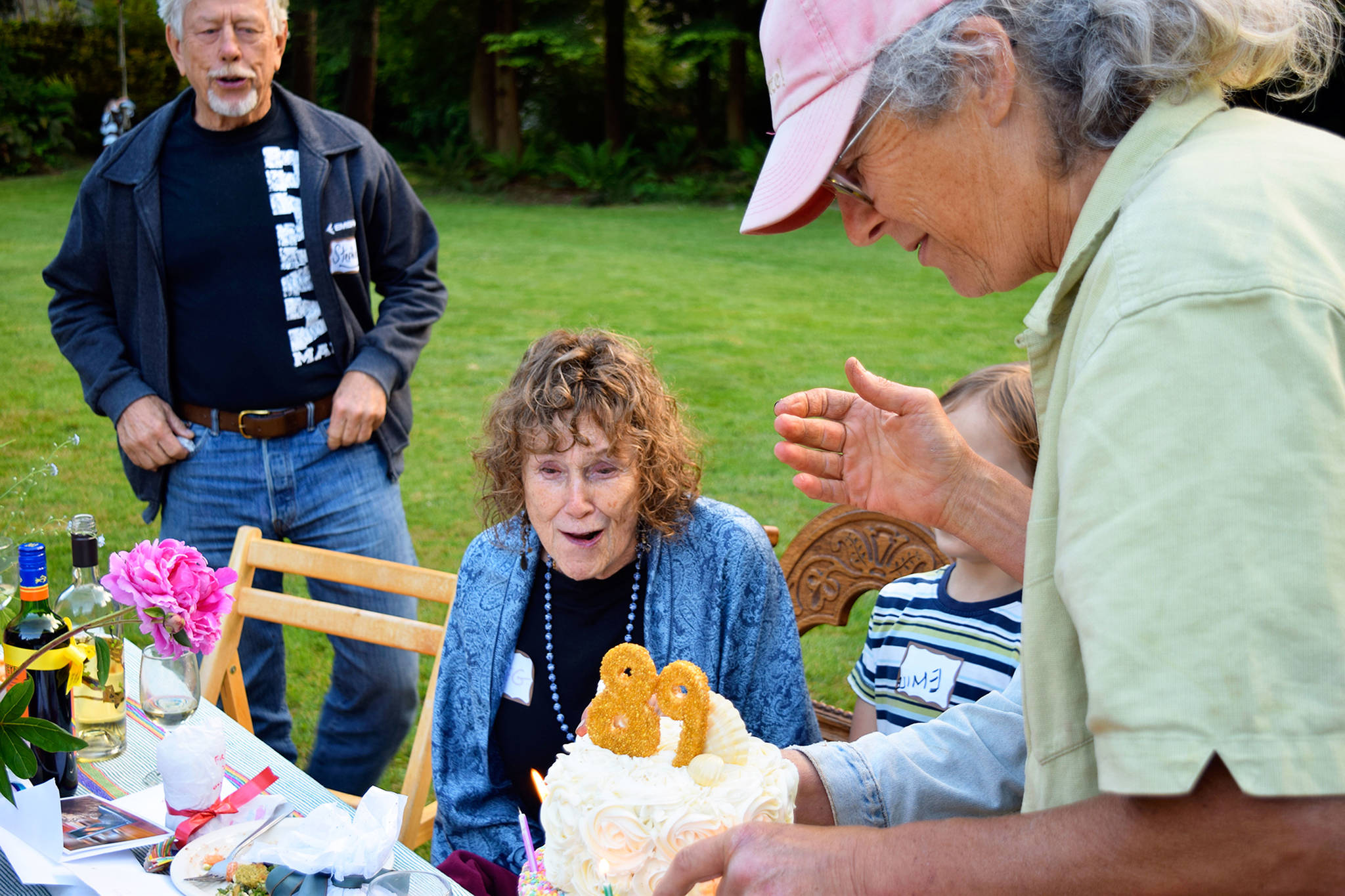 Cary Peterson (right) presents her mother, Meg Noble Peterson, with a birthday cake recently at a Langley neighborhood picnic. Peterson, who just turned 89, is representative of Whidbey Island’s ranking as a leader in longevity. Photos by Patricia Guthrie/Whidbey News-Times