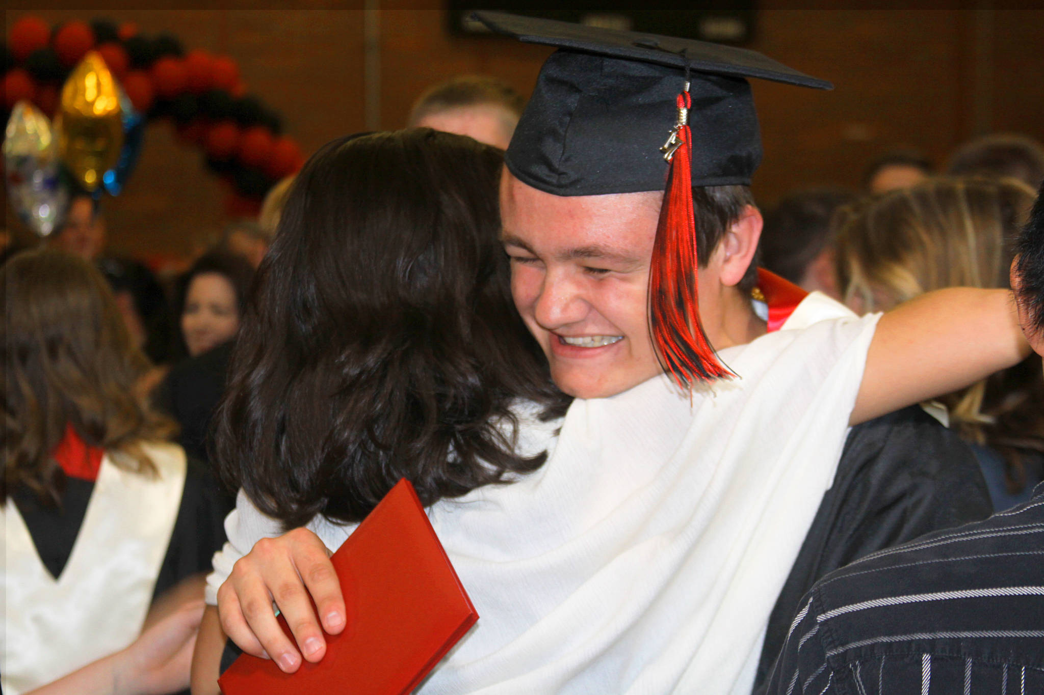 Grey Rische gets a hug following the commencement ceremony for Coupeville High School’s Class of 2017 Friday night, June 9, 2017. Photo by Ron Newberry/Whidbey News-Times