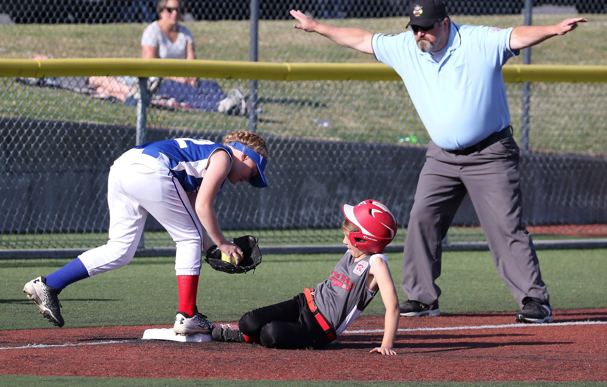 Central Whidbey’s Mia Farris slides in safely at third base in the district opening game Tuesday. (Photo by John Fisken)