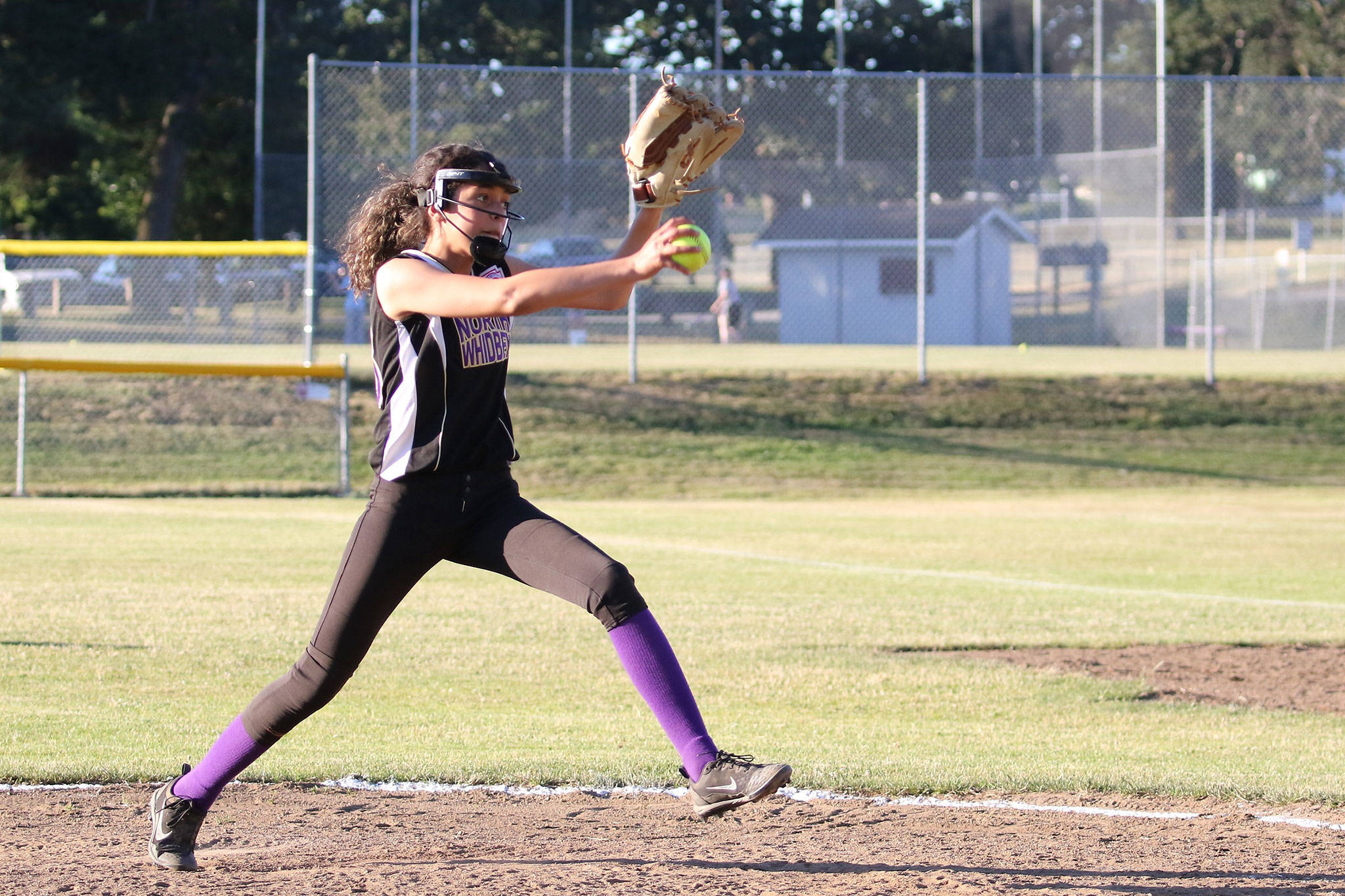 Macy Oliver fires a pitch in Friday’s game. Oliver was the winning pitcher in both games this weekend as North Whidbey claimed the district title. (Photo by John Fisken)