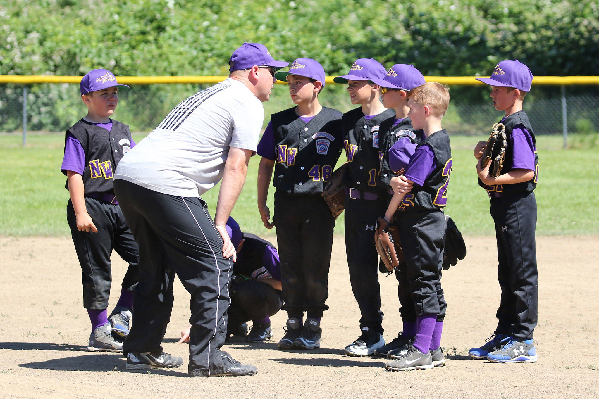 Assistant coach Ryan Grabner gives North Whidbey a pep talk Saturday. (Photo by John Fisken)