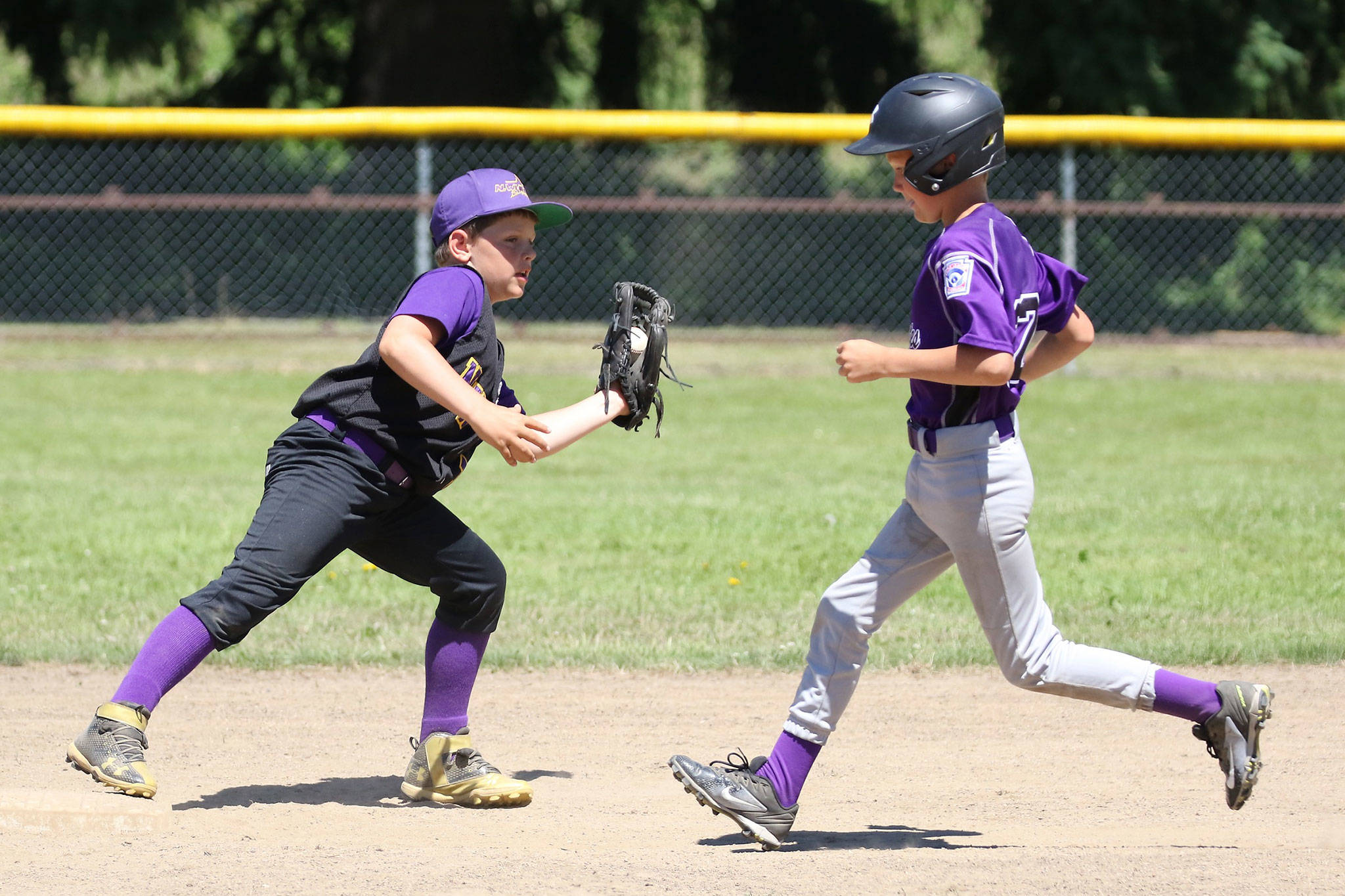 Connor Cash forces an Anacortes runner at second base for North Whidbey. (Photo by John Fisken)
