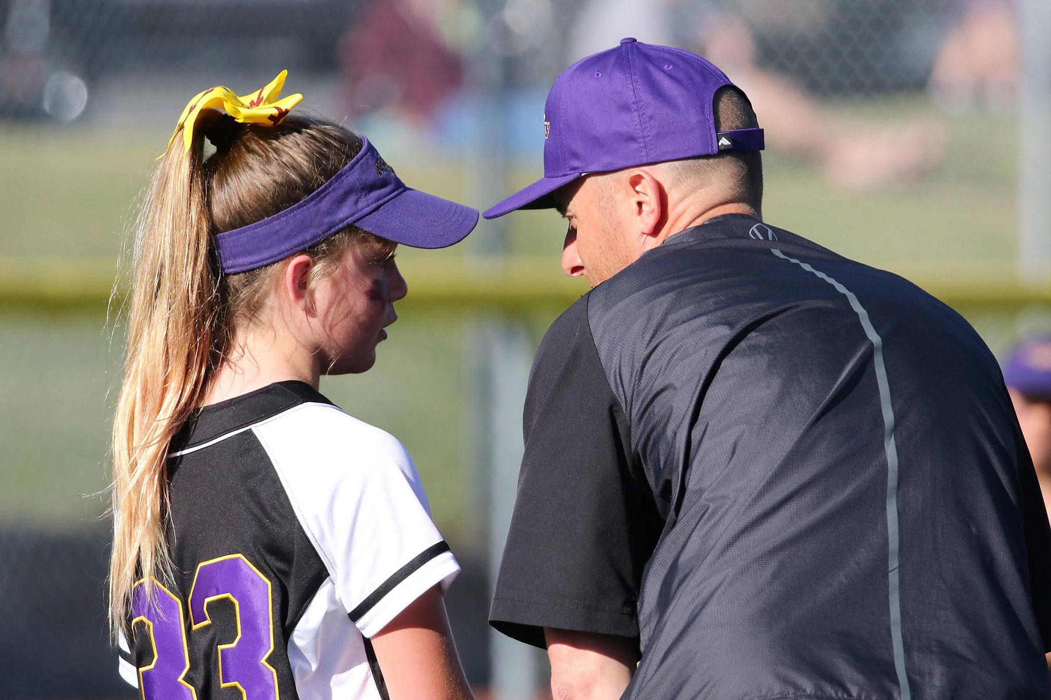 Pitcher Reese Wasinger receives some encouraging words from her coach and father, Brian Wasinger. (Photo by John Fisken)