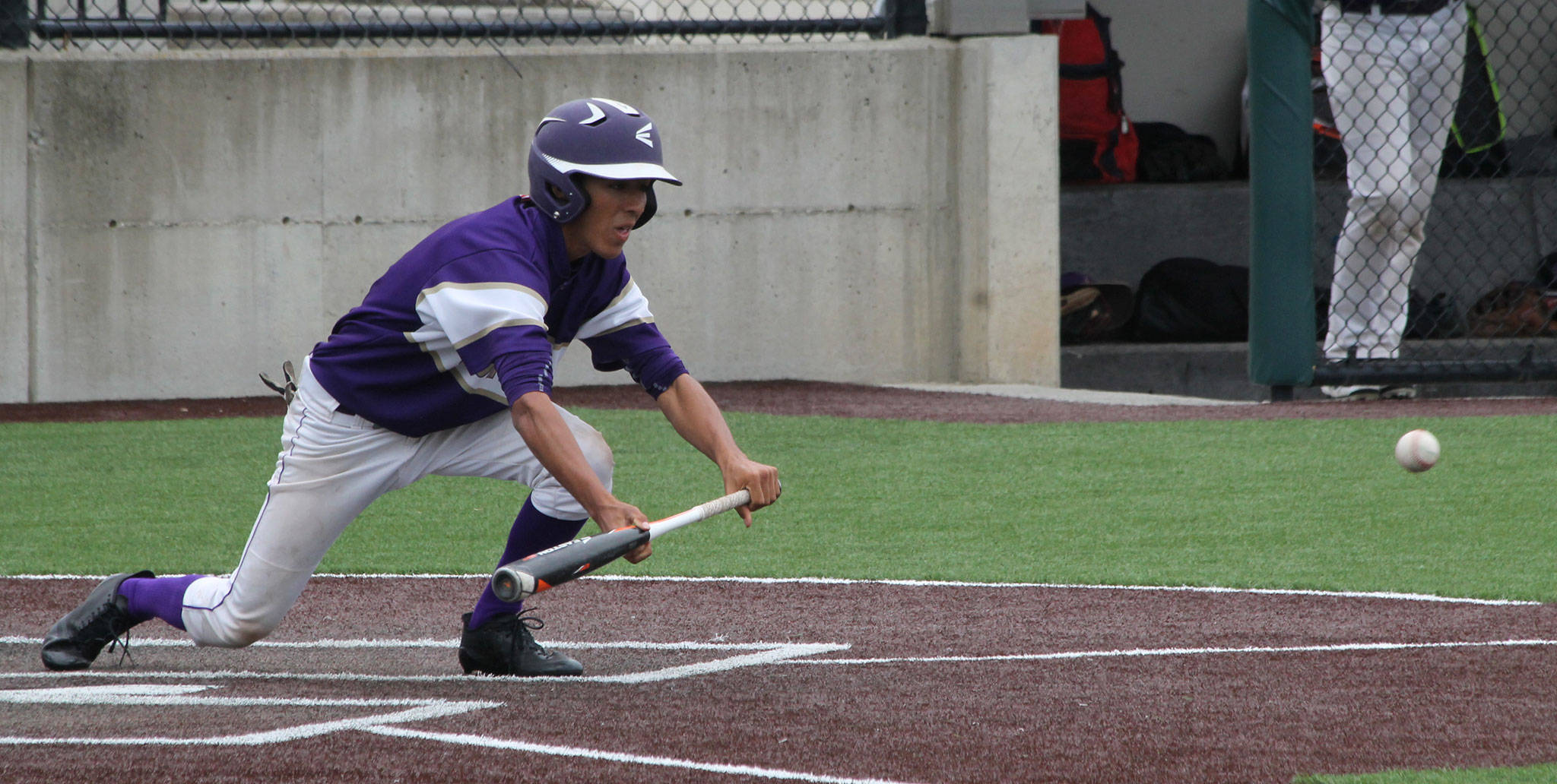 Caleb Fitzgerald puts down a squeeze bunt to score the Wildcats&rsquo; winning run Saturday. (Photo by Jim Waller/Whidbey News-Times)
