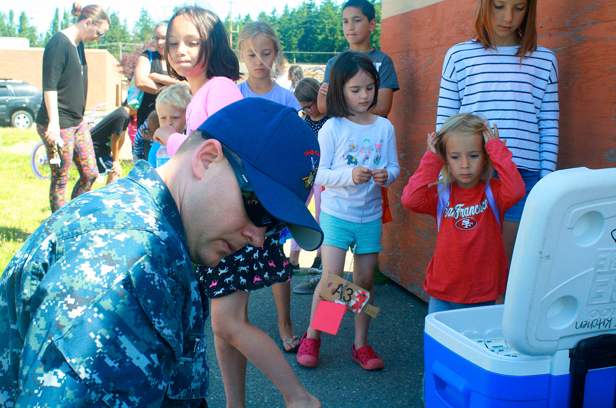 Rory Taylor, U.S. Navy petty officer second class, volunteers at Crescent Harbor Elementary June 29, where he assembles and distributes free sack lunches for children 18-and-under for Oak Harbor Public Schools’ summer lunch program. Photo by Daniel Warn/Whidbey News-Times