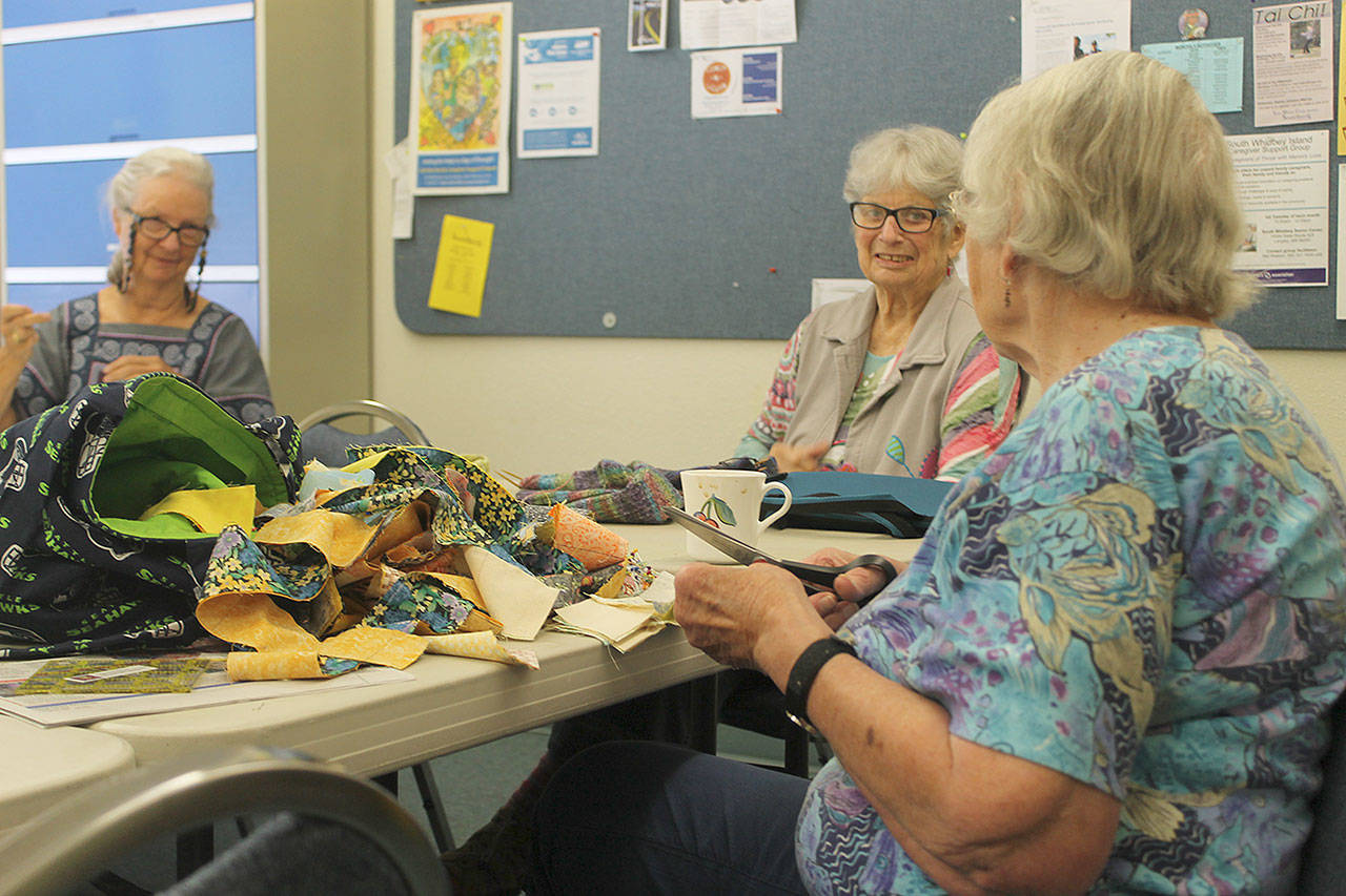 Three of the Crazy Quilter’s members chat on July 19 at the South Whidbey Senior Center. From left to right:Evelyn Blair, Doris Northcutt and Jenny Mayer. Photo by Evan Thompson/ Whidbey News Group
