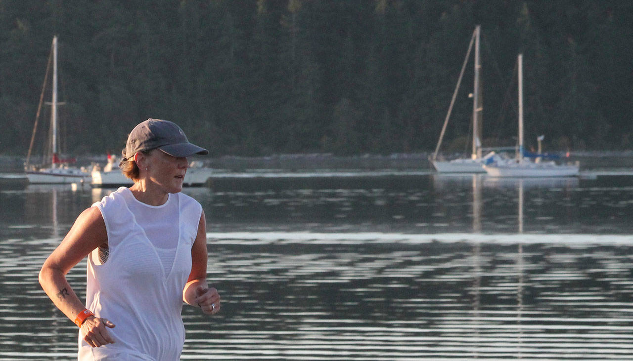 Oak Harbor&rsquo;s Sandee Waller runs along Flintstone Freeway during the Ragnar Relay. (Photo by Jim Waller/Whidbey News-Times)