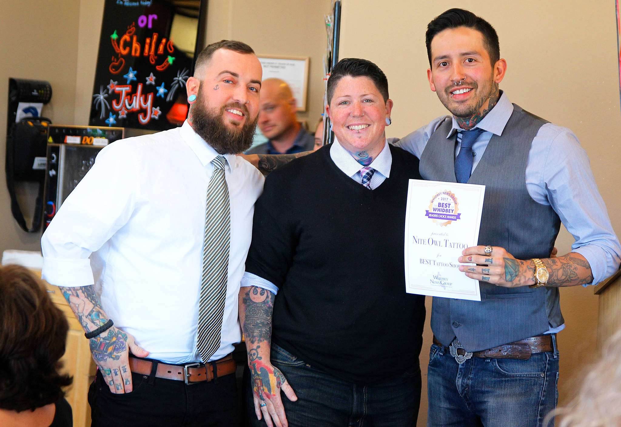 Seth Smith, Molly Vigallon and William Lloyd of Nite Owl Tattoo accept an award for Best Tattoo Shop. Photo by Megan Hansen/Whidbey News-Times