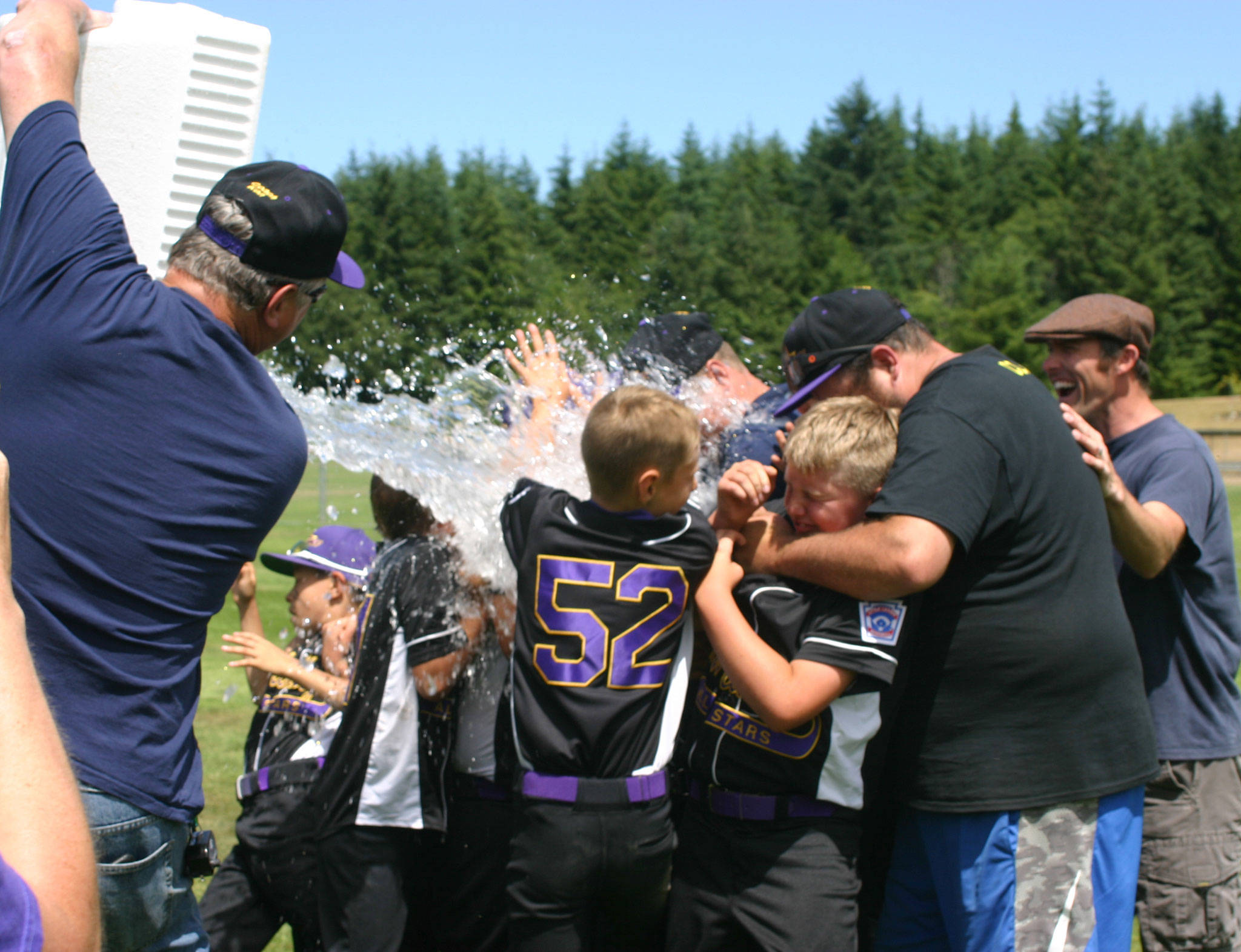 North Whidbey celebrates the district title as assistant coach Ken Harrison gives them a victory shower. (Submitted photo)
