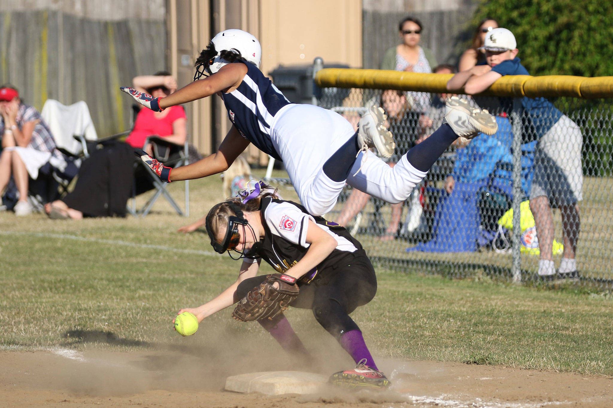 Mill Creek’s Simone Williams, top, collides with Emily Wilson at first base in Thursday’s game. Williams was out on the play. (Photo by John Fisken)