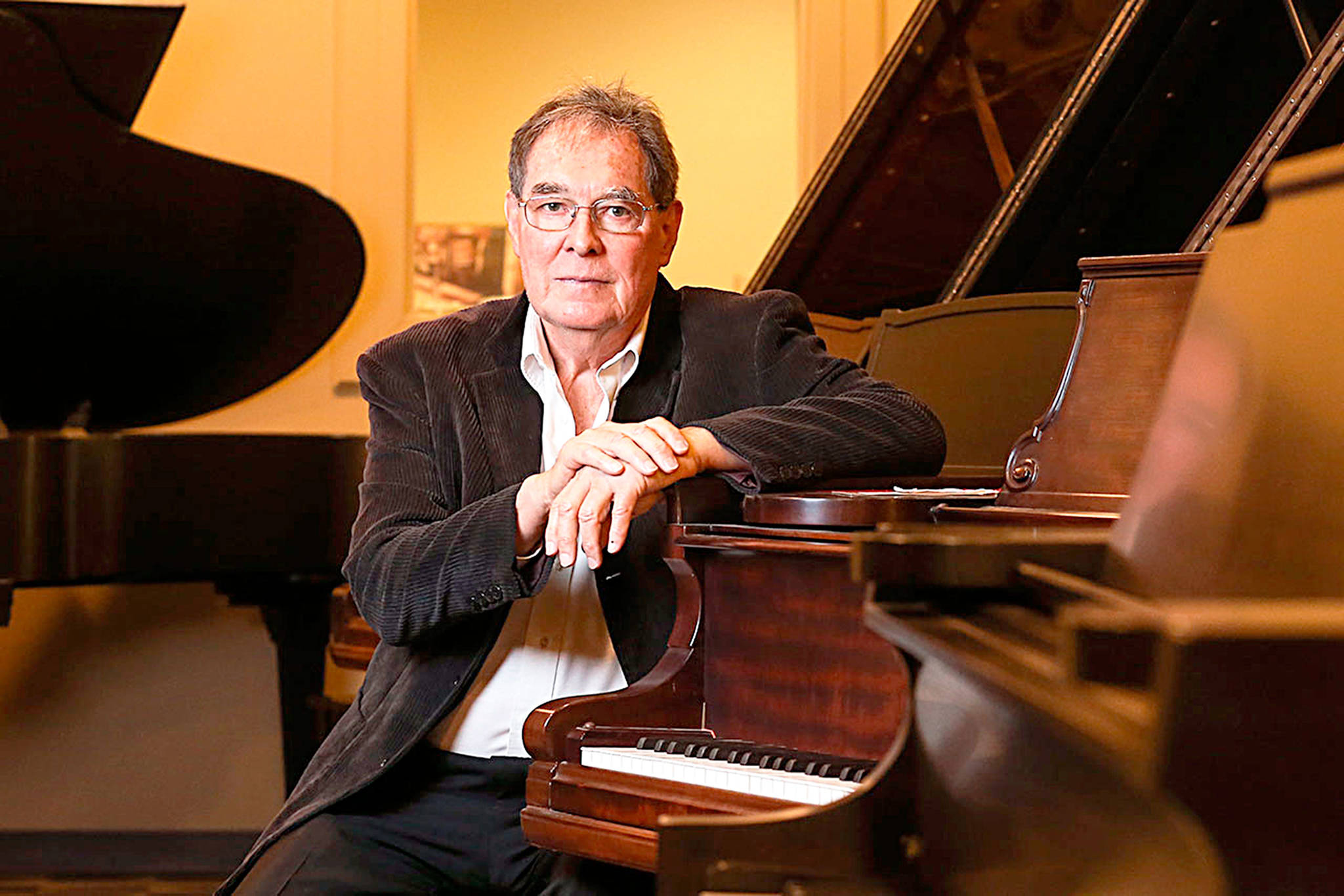 Lloyd Boyd has become Whidbey’s Piano Man following the death of his brother, Ronald Boyd, who stored his collection of Steinways and other rebuilt grand pianos in Greenbank. Photo by Kevin Clark/The Herald