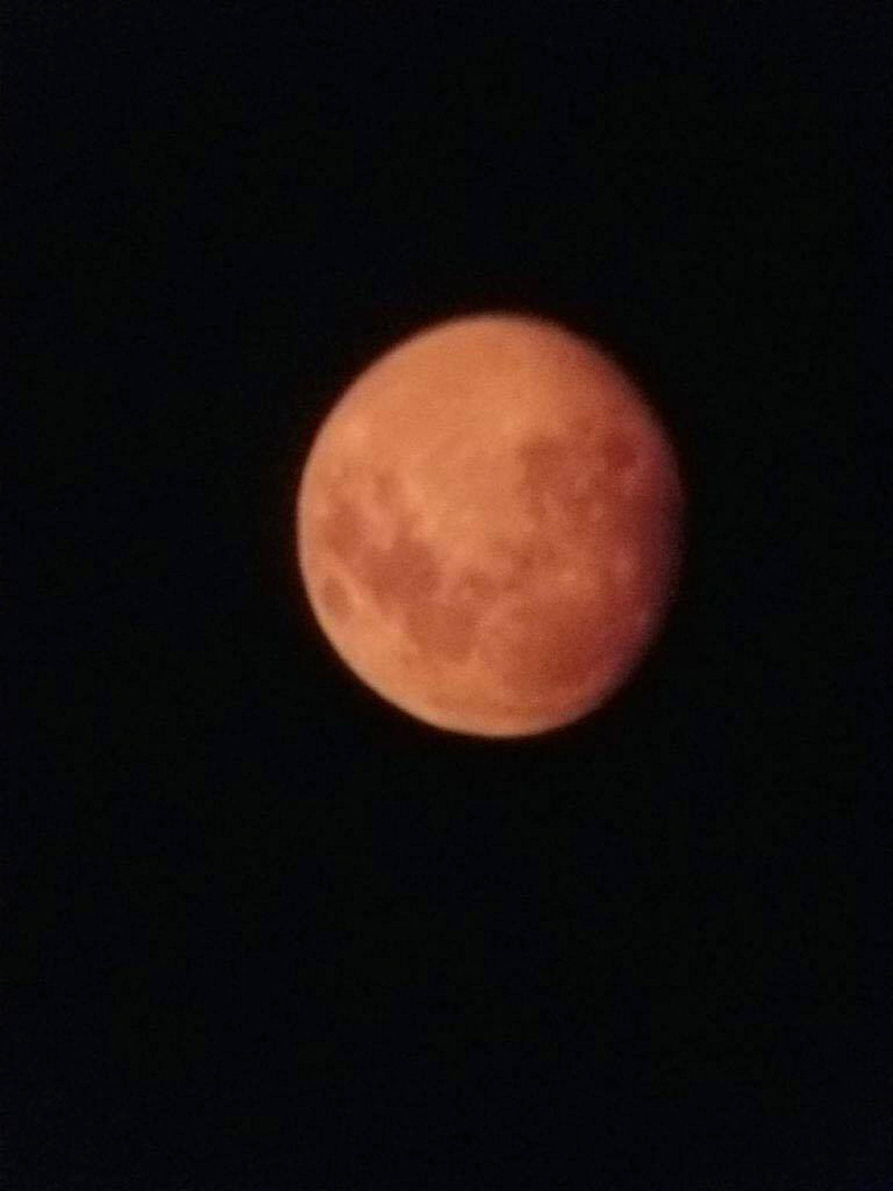 Islanders Raul and Kari Hernandez captured the orange moon through the lens of their telescope Friday. Photo by Raul Hernandez
