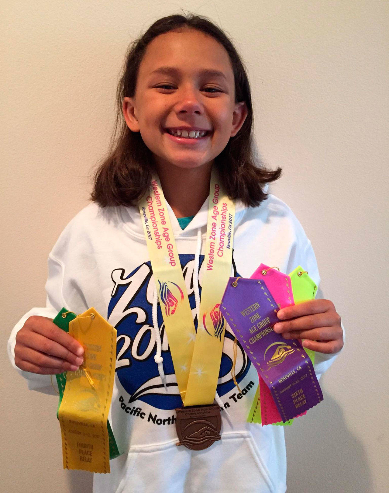 Haley Borja could use a few more hands to hold the awards she collected at the zone championships. (Submitted photo)