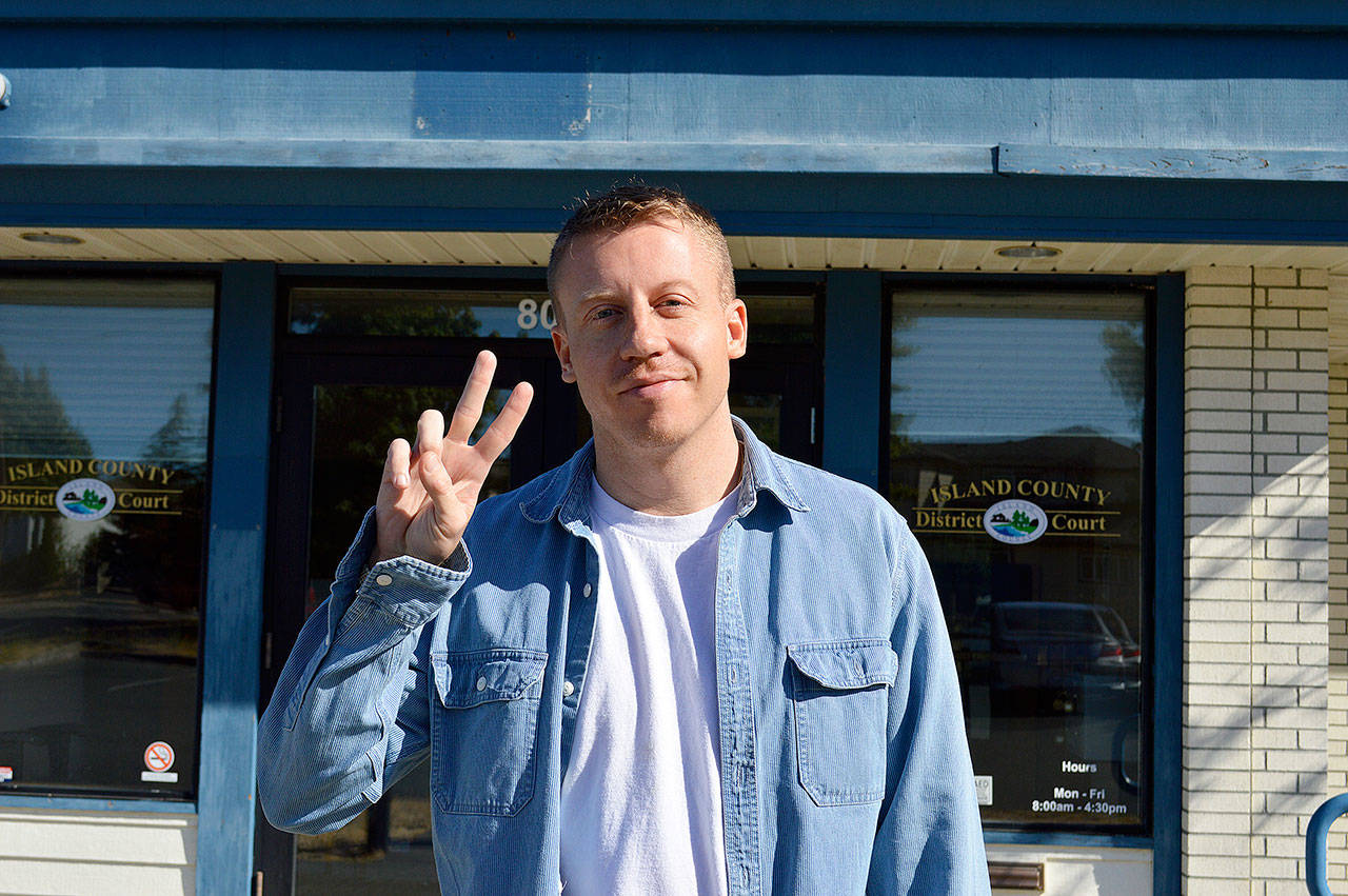 Macklemore flashes the peace sign outside Island County District Court Monday after paying a fine for driving with a suspended license. Photo by Laura Guido/Whidbey News-Times