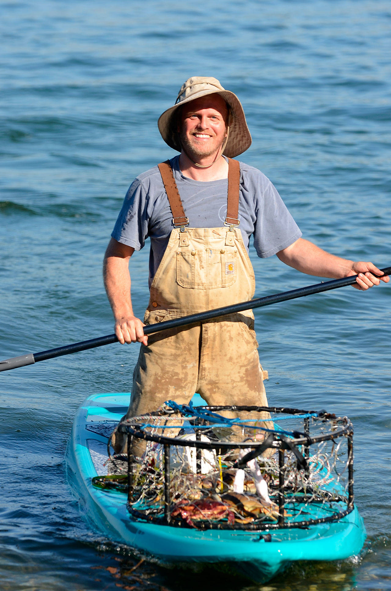 Justin Burnett / The Record — Stewart chose to drop and collect his crab pots with a paddleboard after realizing it was quicker and more environmentally friendly.
