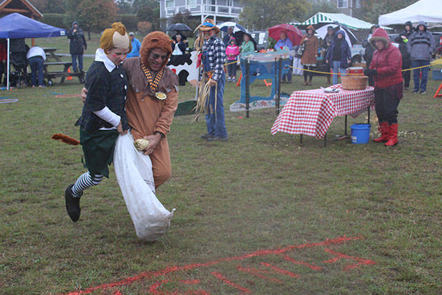 2016 file phioto/Whidbey News-Times                                Participants run a two-person sack race during last year’s Harvest Relay Races. Teams raised money for Gifts from the Heart food bank.