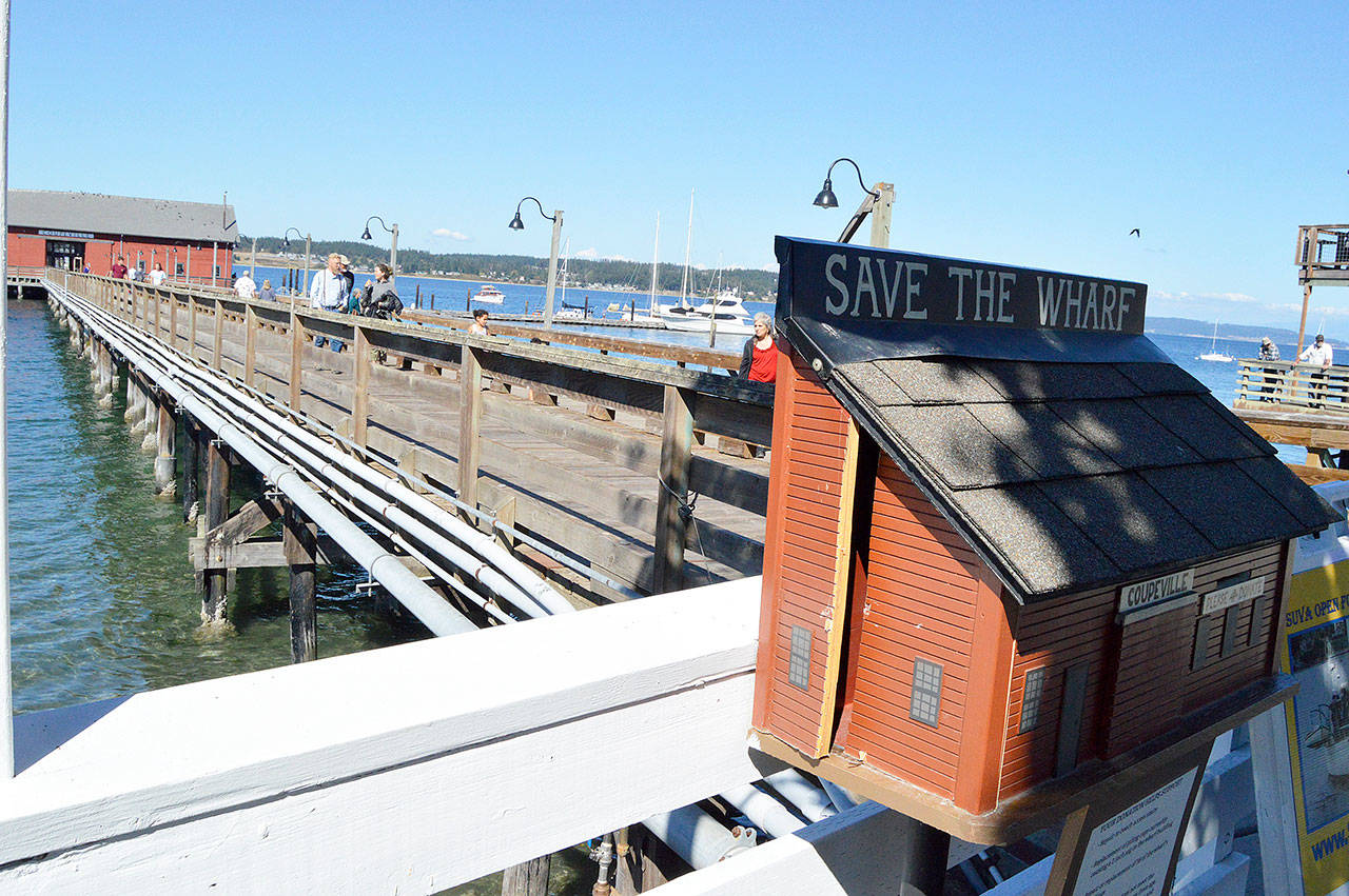 A mini Coupeville Wharf collection box to raise funds for projects at the historic public structure was kicked in any money inside stolen in early August. Photo by Megan Hansen/Whidbey News-Times
