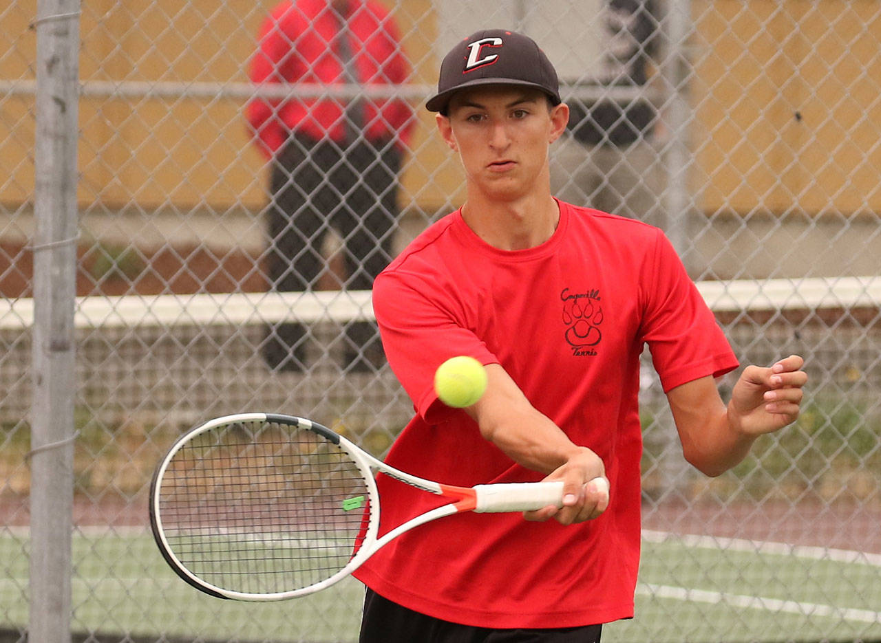 Joey Lippo returns a shot in first doubles. (Phboto by John Fisken)