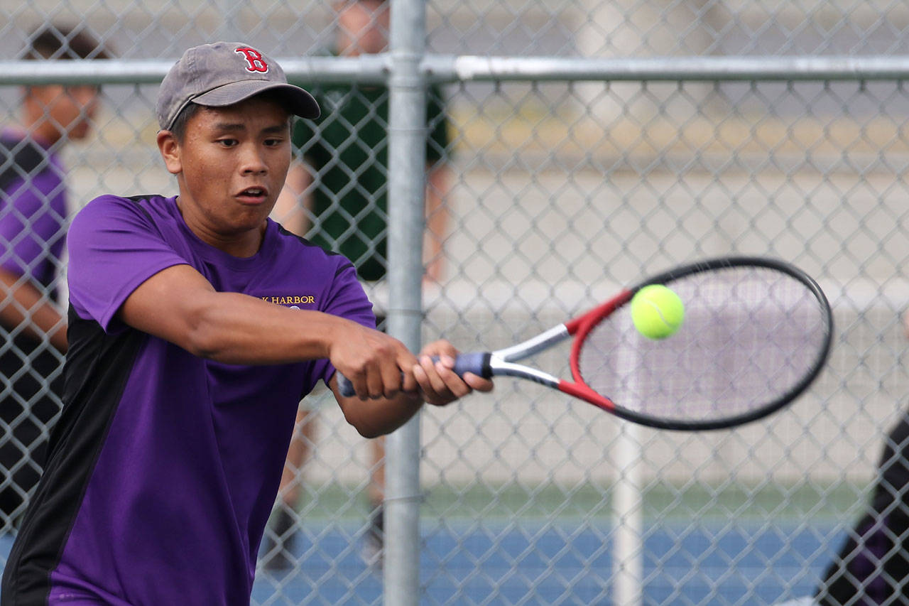 Ryan Mene, who won fourth singles, strokes a backhand shot Friday. (Photo by John Fisken)