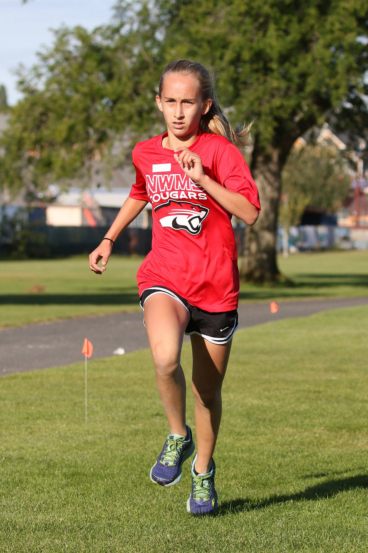 Logan Badura places fourth in the eighth-grade girls race Wednesday. (Photo by John Fisken)