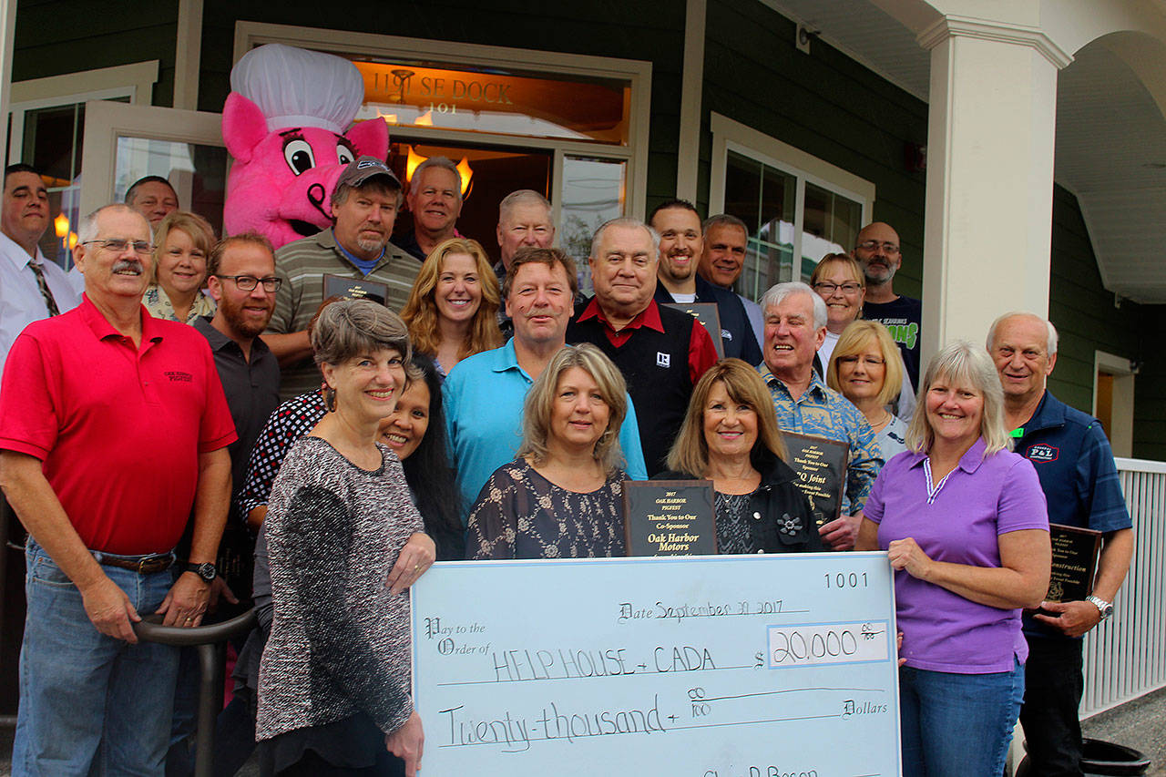 Pigfest organizers presented a $20,000 check to Help House and CADA Friday at a gathering of about 25 sponsors. Accepting the check is Cynde Robinson (left) director of CADA and Jean Wieman, director of Help House. Money raised at the annual free summer event comes from crowd donations.                                Photo by Patricia Guthrie/Whidbey News-Times