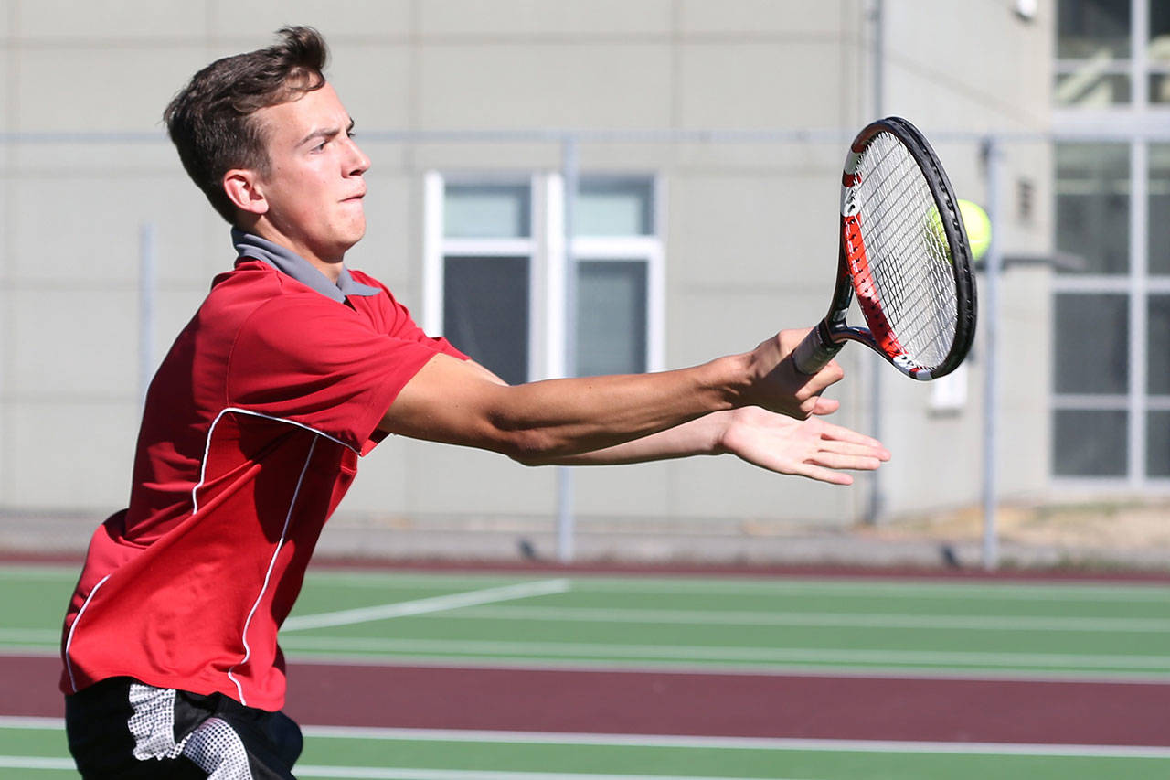 Coupeville’s Nick Etzell returns a shot in his second doubles win with partner Mason Grove. (Photo by John Fisken)
