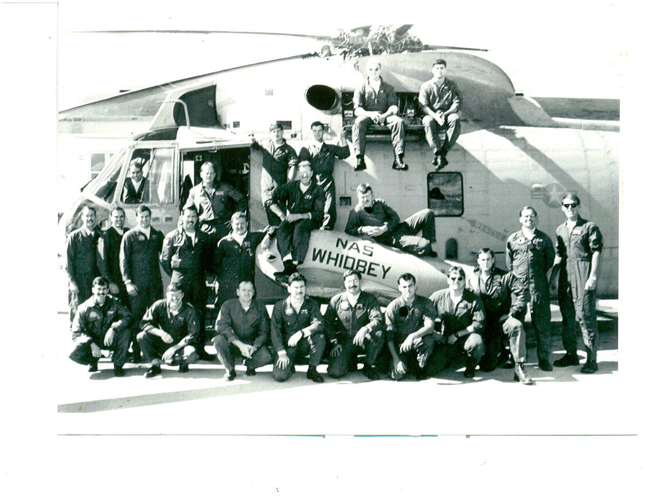 The team of Whidbey Island Search and Rescue members in 1986 gather around their Sikorsky H3 Sea King helicopter. Photo provided by Robert Davison