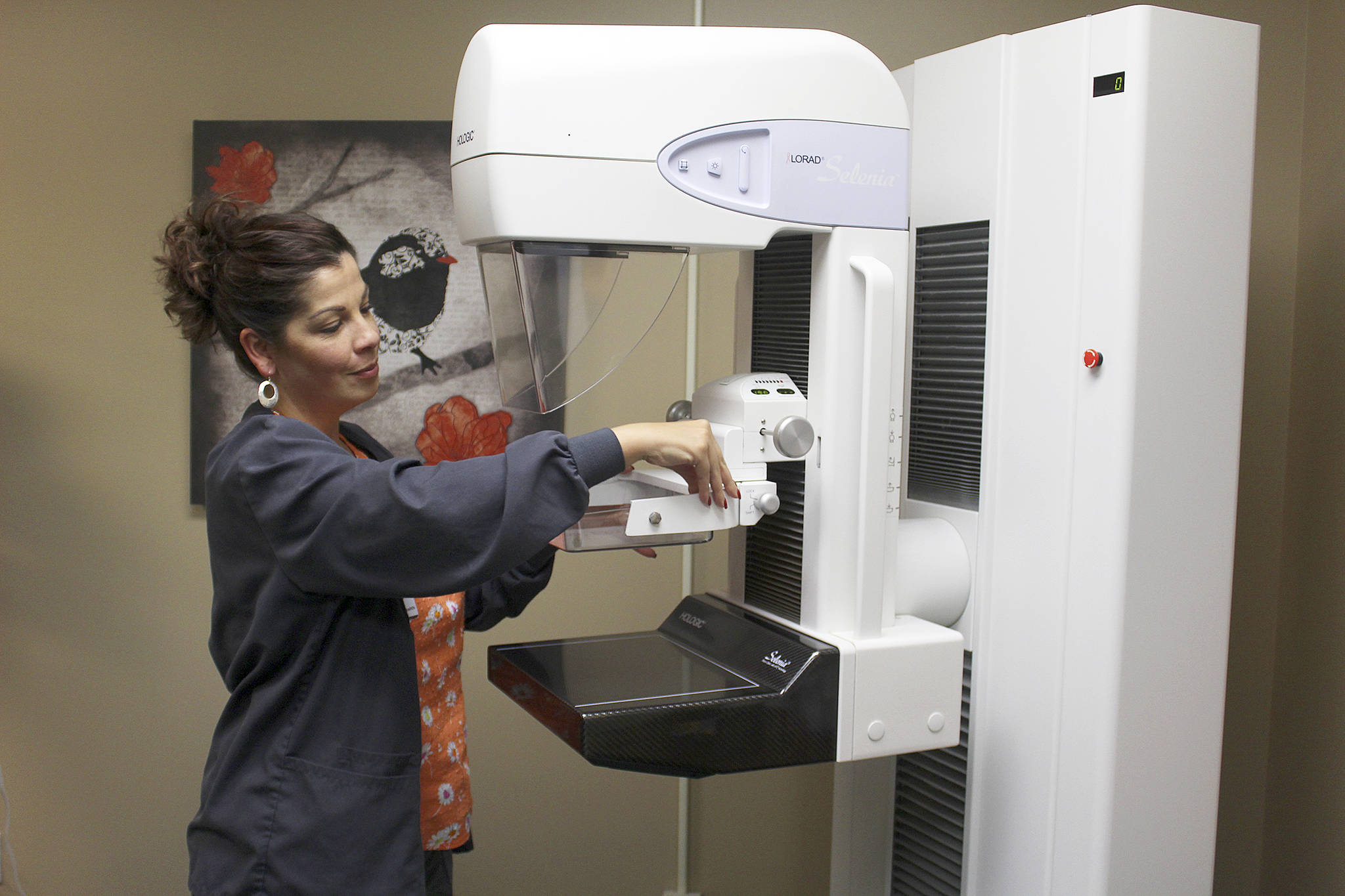 Stephanie George, lead mammogram technician at WhidbeyHealth Medical Center, cleans the imaging machine in between patients. Photos by Patricia Guthrie/Whidbey News-Times