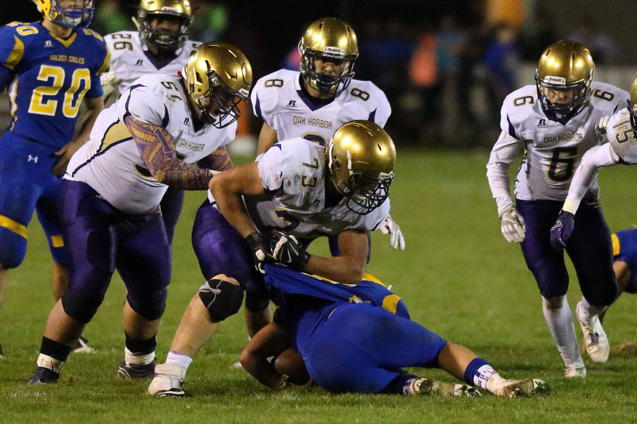 The Wildcats trap a Ferndale ball carrier in last year’s game. (Photo by John Fisken)