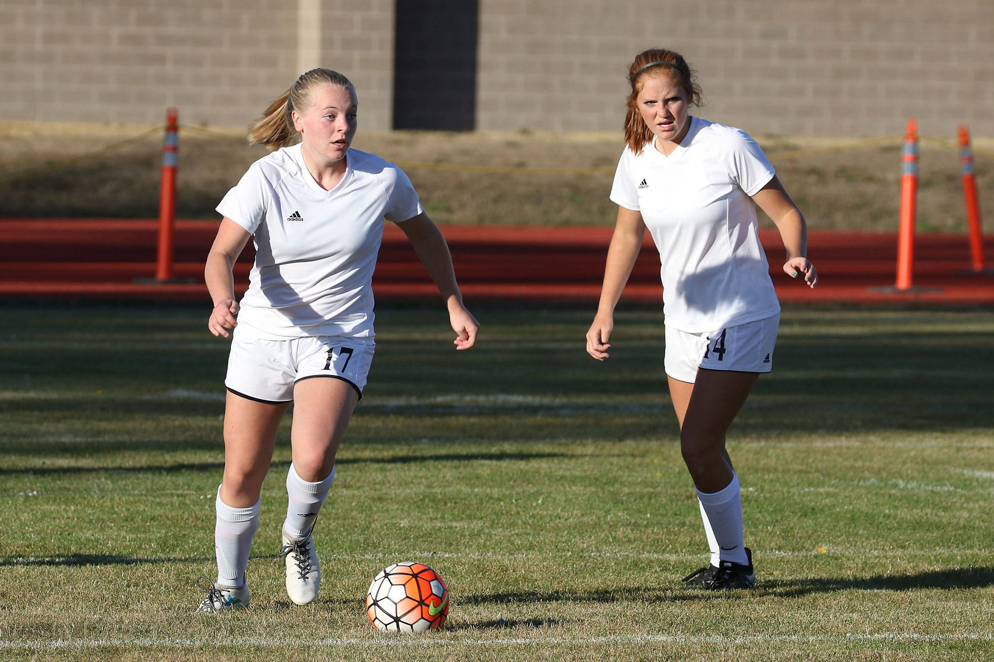 Sage Renninger, left, looks for an opening as Ema Smith trails the play.(Photo by John Fisken)
