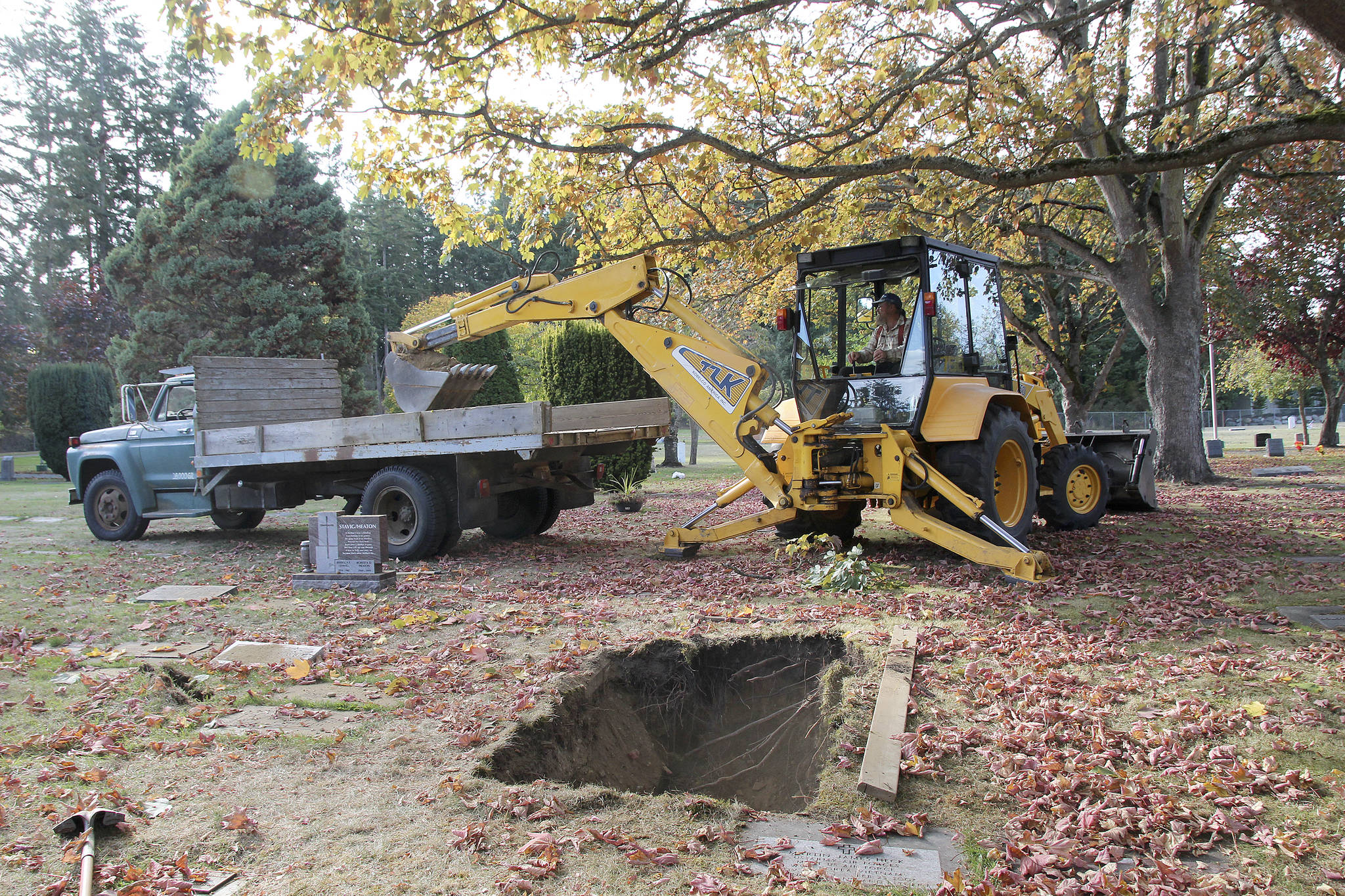 Jessie Stensland / Whidbey News-Times                                Mike Case Smith digs a grave with a backhoe in Oak Harbor’s Maple Leaf Cemetery this week.